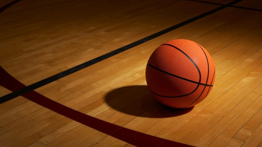 Basketball Spotlight on Hardwood Court wallpaper