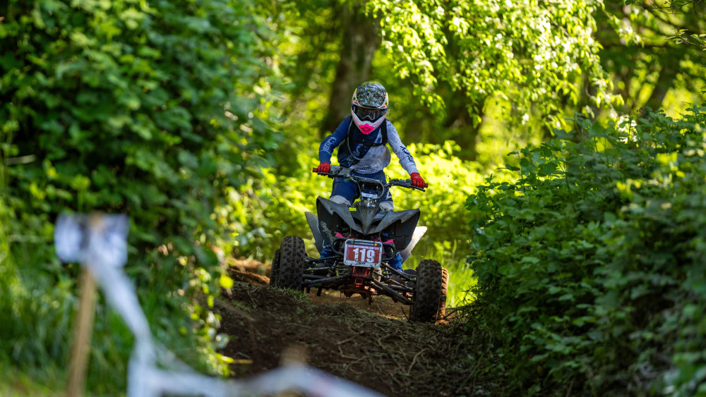 Forest Quad Rider Charging Through Trail wallpaper
