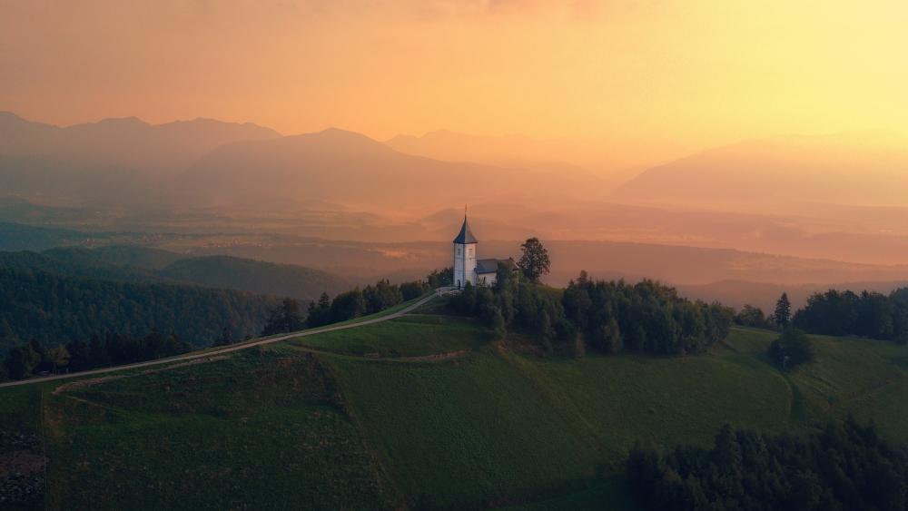 Misty Sunrise Over Jamnik Hilltop Church wallpaper