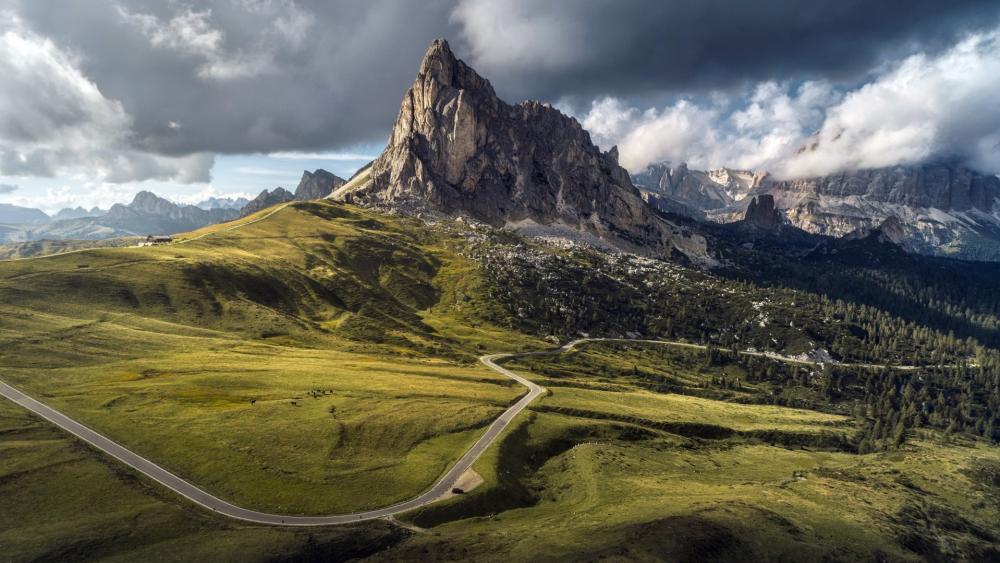 Dolomite Peaks Under Stormy Skies wallpaper