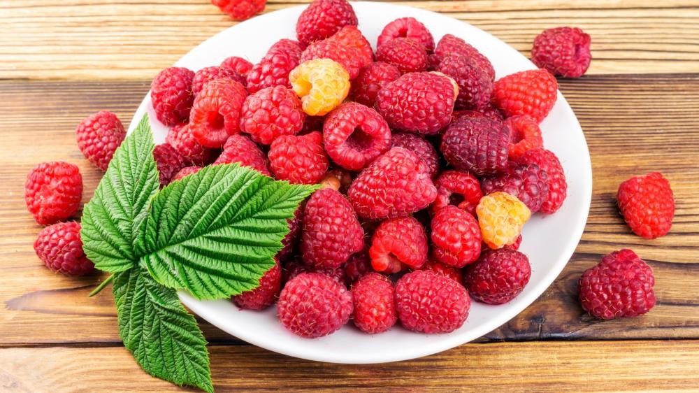 Fresh Raspberry Harvest on Rustic Wood wallpaper