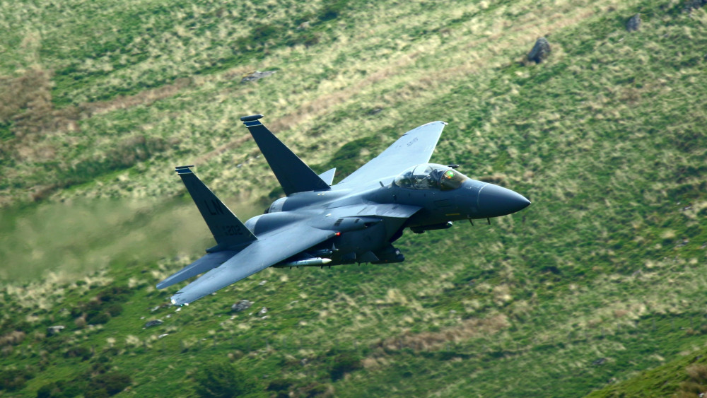 Fighter Jet Over Mountain Valley wallpaper