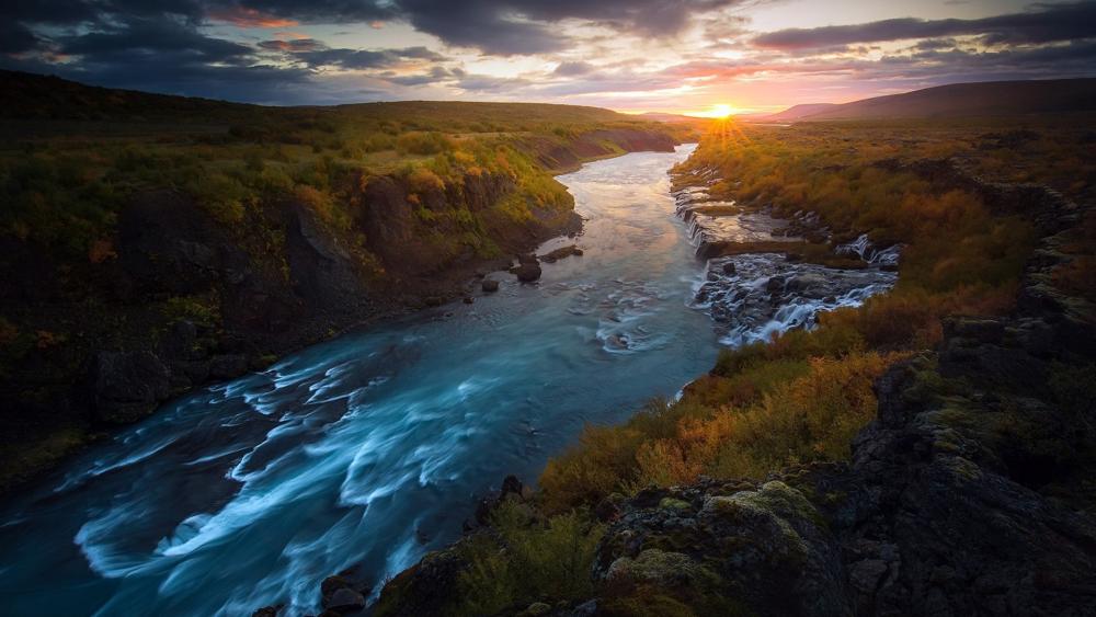 Golden Sunset Over Hraunfossar River Valley wallpaper