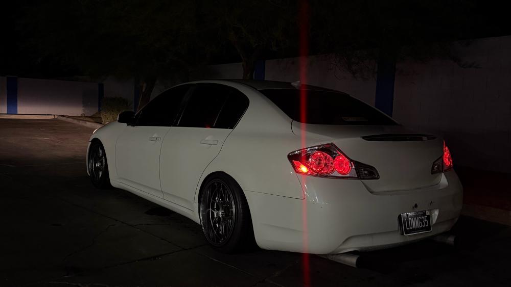 Sleek White Infiniti G35 at Night wallpaper