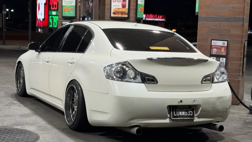 Sleek JDM Infiniti G35 at Nighttime Fuel Stop wallpaper