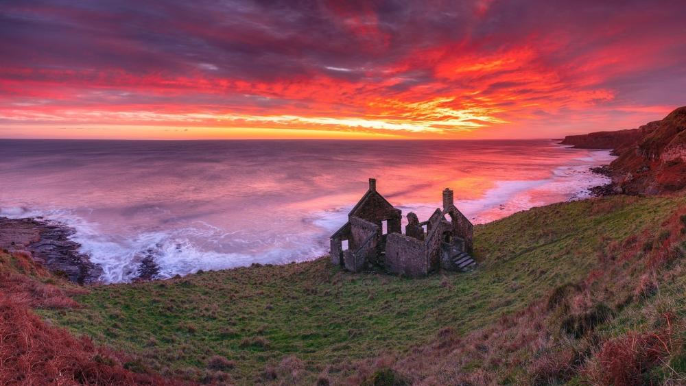 Firelit Coastal Ruins at Lamberton Skerrs wallpaper