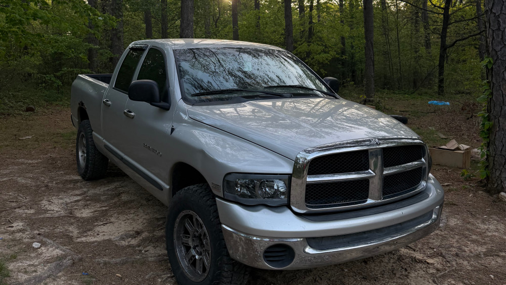 Forest Parked Dodge Ram Under Soft Sunlight wallpaper