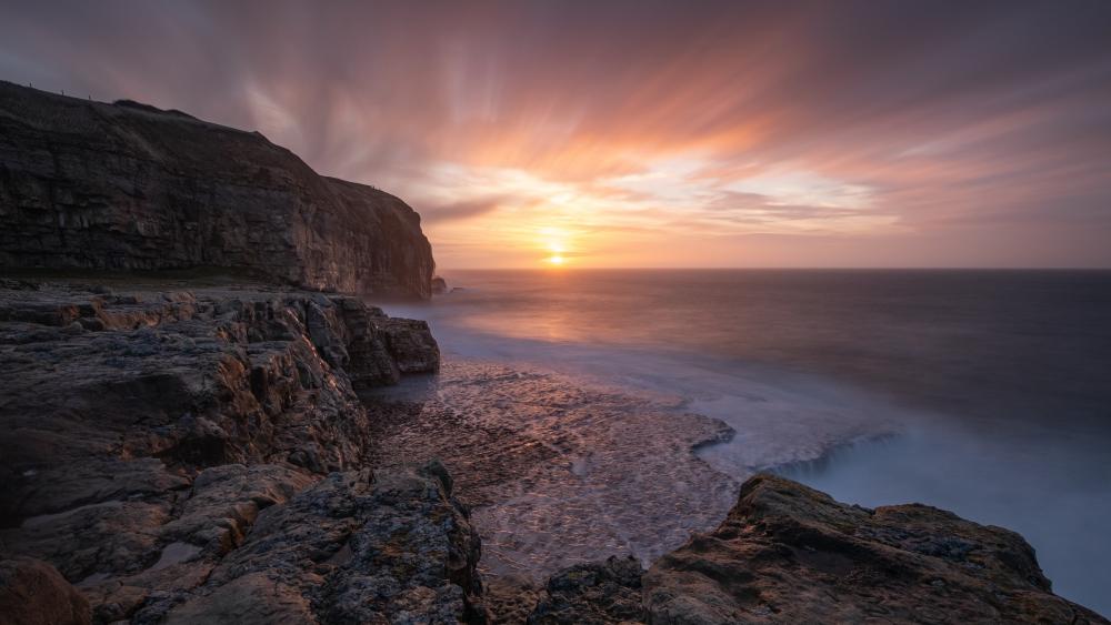 Cliffside Sunset Over the Silent Ocean wallpaper