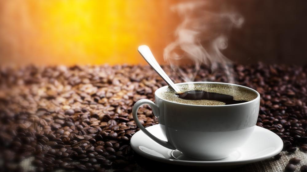 Steaming Coffee Cup on Beans wallpaper