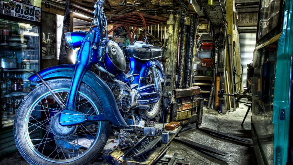 Vintage Blue Motorcycle in Cluttered Garage wallpaper