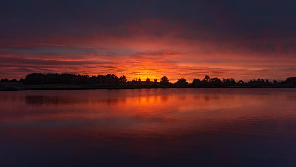 Stunning Orange Sunset Over Serene Lake View wallpaper