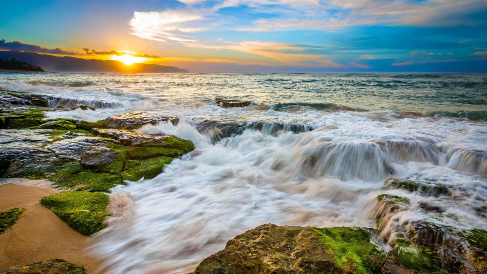 Sunlit Waves Over Mossy Shoreline wallpaper