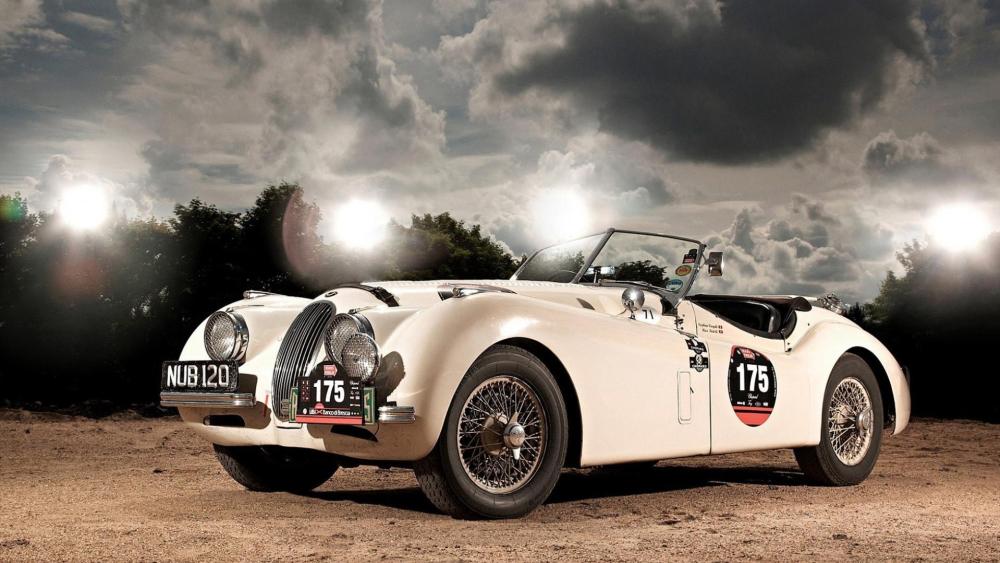 Classic Jaguar XK120 Under Stormy Skies wallpaper