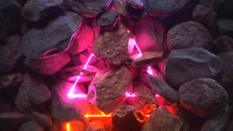 Neon Radiance Amidst Charcoal Rocks wallpaper