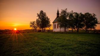 Serene Sunset Over a Tranquil Chapel wallpaper