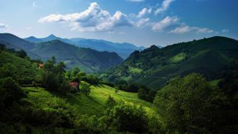 Majestic Green Mountains in a Serene Valley wallpaper