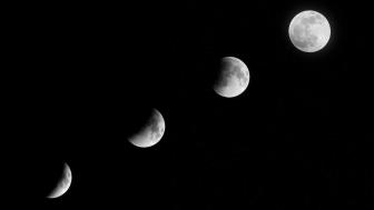 Phases of the Moon Against Night Sky wallpaper