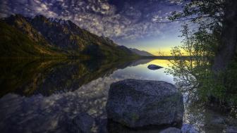Serene Lake Reflection with Boulder and Mountains wallpaper