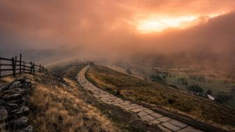 Fog Embraced Pathway in Sunrise Splendor wallpaper