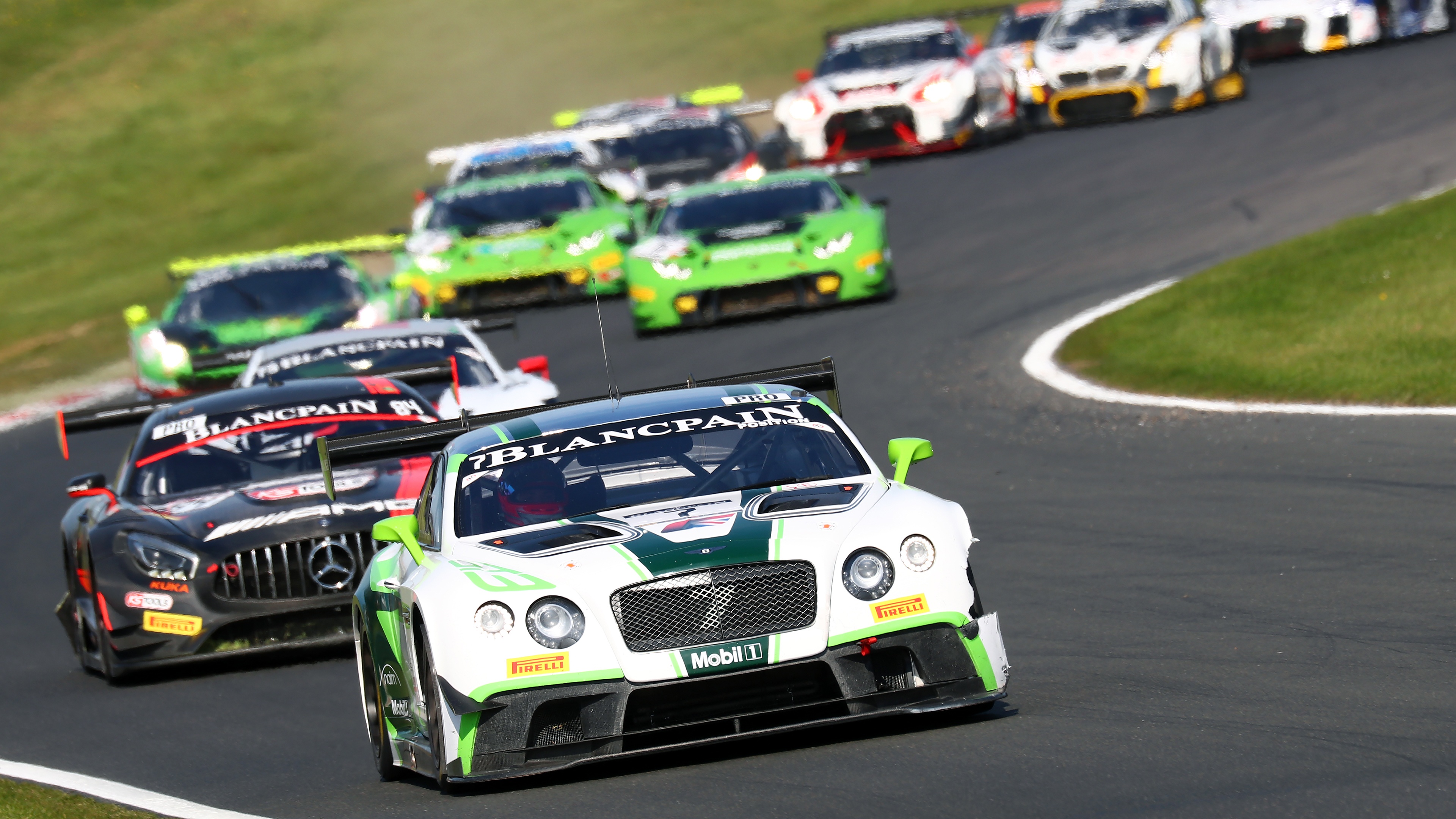 High Speed GT Racing Pack Charging Through a Sweeping Corner - backiee