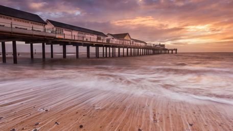 Serene Sunset Over Quiet Pier Beach Scene wallpaper
