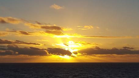 Golden Horizon Embraces the Ocean Waves wallpaper