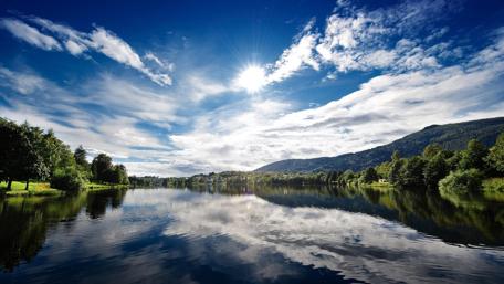 Tranquil River in Sunlit Landscape wallpaper