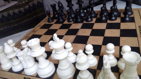 Strategic Clash of Black and White Pieces wallpaper