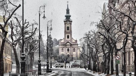 Snowy City Street Leading to Majestic Church wallpaper
