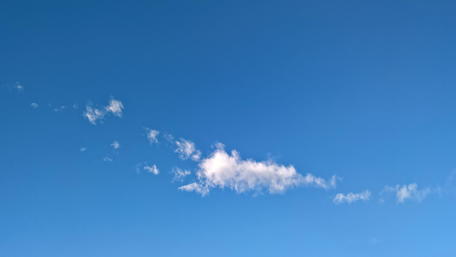 Serene Blue Sky with Whimsical Clouds wallpaper