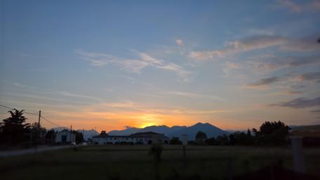 Serene Sunset Over the Mountains in Spring wallpaper