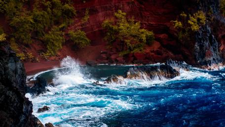 Vivid Waves Against Red Cliffs in Paradise wallpaper