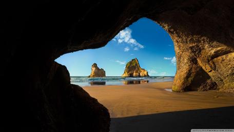 Serene Coastal Escape Amidst Majestic Rock Formations wallpaper