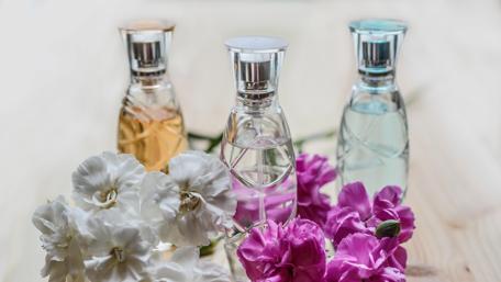 Elegant Perfumes Surrounded by Flowers wallpaper