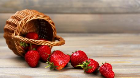 Fresh Strawberries in a Rustic Basket for Spring Decor wallpaper