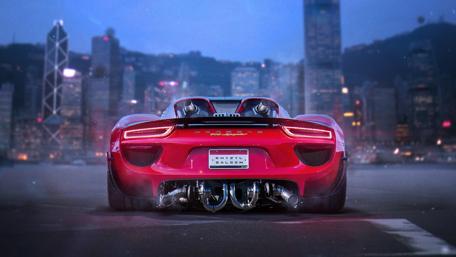 Gleaming Red Porsche 918 Against City Lights wallpaper