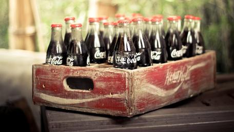 Vintage Coca-Cola Bottles in Rustic Crate wallpaper
