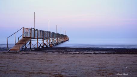 Serene Pier at Dusk Over Calm Waters wallpaper