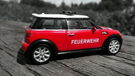 Miniature Firefighter Car in Red Hue wallpaper