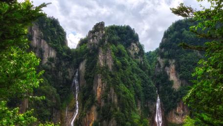 Majestic Waterfalls in Lush Green Mountains wallpaper