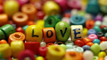Colorful Love Amidst Vibrant Beads wallpaper