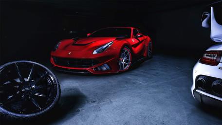 Stunning Red Ferrari in Dark Garage Space wallpaper