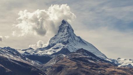 Majestic Mountain Peaks Under Dramatic Skies wallpaper