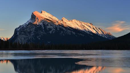 Majestic Mountain at Sunrise Reflecting in Still Waters wallpaper