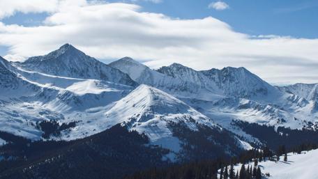 Majestic Snow-Capped Mountains Under a Clear Blue Sky wallpaper