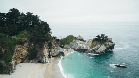 Serene Coastal Escape Amidst Towering Cliffs wallpaper