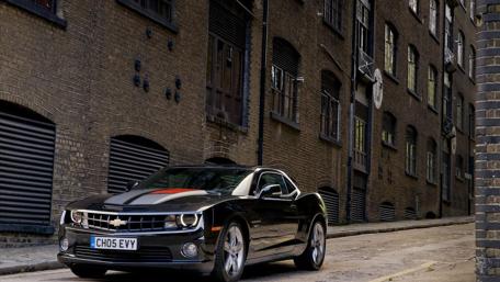Sleek Black Camaro in Urban Alleyway wallpaper