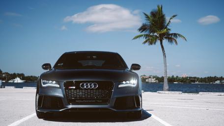 Sleek Black Audi Under Clear Blue Sky wallpaper