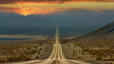 Endless Road Under Vibrant Sunset Sky wallpaper