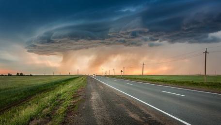 Majestic Road Beneath Dramatic Skies wallpaper